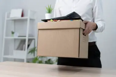 Movers loading furniture onto a truck for office relocation