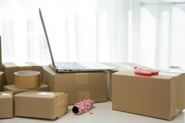  Employees packing boxes with essential supplies for office relocation