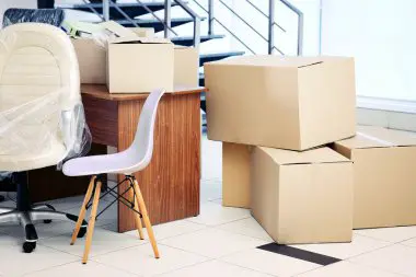 Employees packing boxes for office relocation