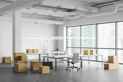 Movers packing office equipment for relocation